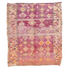 an old rug with pink and orange colors