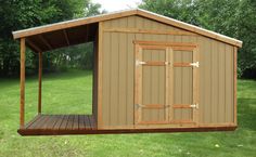 a small shed sitting on top of a lush green field