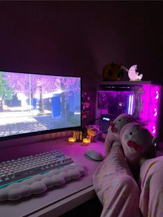 a person laying in front of a computer with a keyboard and mouse on the desk