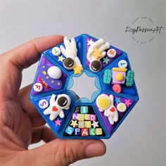 a hand holding a toy that looks like it is made out of magnets and plastic