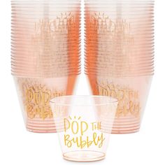 pink plastic cups with gold foil lettering and straws in the bottom one cup says pop the bubbly