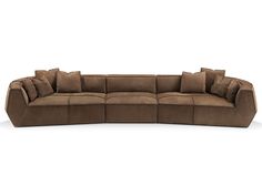 a large sectional couch with pillows on the top and bottom corner, in brown sued