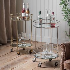 two metal drinks trolleys with wine glasses on them