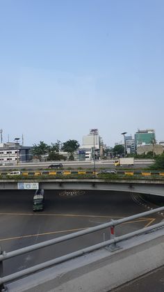 an overpass with cars driving on it and buildings in the background