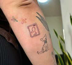 a person with a tattoo on their arm has a dog and cat in the frame