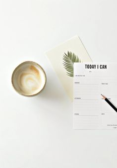 a cup of coffee next to a notepad that says today i can