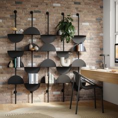 a brick wall with bookshelves and shelves on it, next to a desk