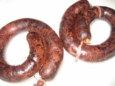 two large sausages sitting on top of a white plate