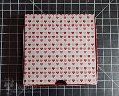 a box with hearts on it sitting on top of a cutting board