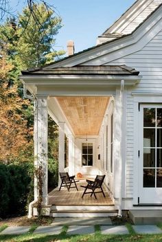 a white house with an awning on the front porch