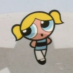 the cartoon girl is flying through the air with her eyes wide open and blonde hair