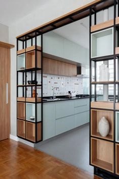 an open kitchen with wooden floors and cabinets