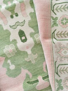 two green and pink rugs sitting next to each other