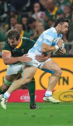 two rugby players in action on the field