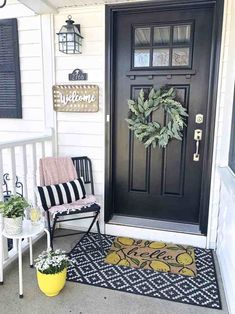 a black front door with a wreath on it