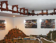 there is a model train set on display in the room with many tracks and trees