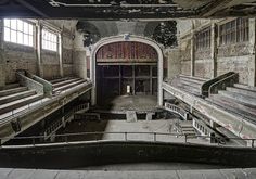 an abandoned building with stairs leading up to the exitway and another set of railings