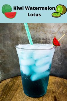 a glass filled with ice and watermelon sitting on top of a wooden table