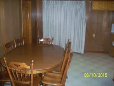 a wooden table and chairs in a room