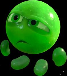 a green ball with two eyes and some rocks