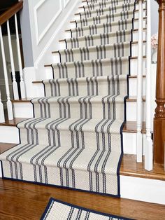 the stairs are lined with blue and white rugs