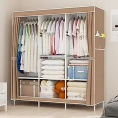 an organized closet with clothes and diapers in the corner, next to a bed