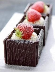 three pieces of chocolate dessert with strawberries on top