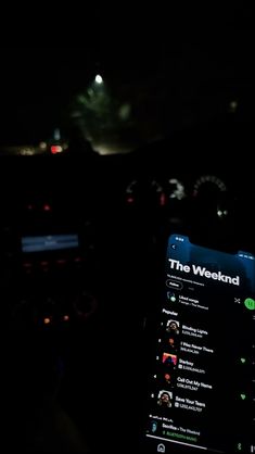 the dashboard of a car at night with an app on it's display screen