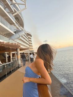 a woman in a blue dress on a cruise ship