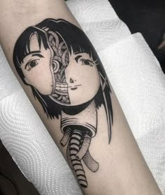 a woman's arm with a black and white tattoo design on the left forearm