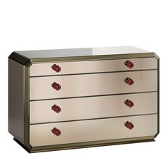 a white and gold dresser with red knobs