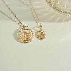 Embrace the essence of growth and evolution with our handcrafted gold-filled Mini Spiral pendant necklace. This elegant piece symbolizes continuous development and life's journey, capturing the beauty of expansion and progress in its timeless design. Perfect for those who appreciate meaningful and exquisite jewelry. Handcrafted in the USA. DETAILS: Material: 14/20 gold-filled, Skin Friendly Dimensions: Pendant 10mm Chain Length 18" plus 2" extender chain Note: As each piece is handcrafted dimensions and shapes can slightly vary ensuring no two are exactly alike. Growth And Evolution, Spiral Pendant, Spiral Necklace, 40th Gifts, 20 Gifts, Beaded Cuff, 30 Gifts, Chain Choker, Cuff Bangles