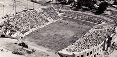 an aerial view of the football field and stadium in black and white with red lettering