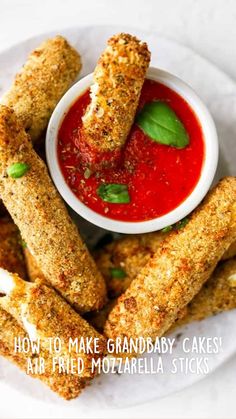 fried chicken sticks with marinara sauce on a white plate