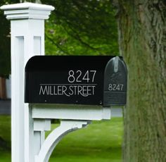 a mailbox with the name miller street written on it in front of a tree