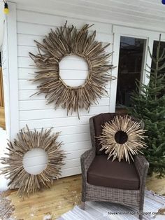 a chair sitting in front of a house with two sunbursts on the wall