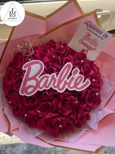 there is a cake that has been decorated with roses and the word barbie on it