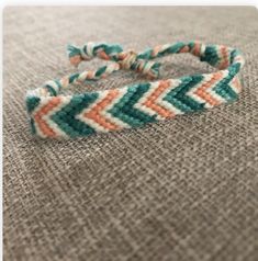 an orange and green bracelet on top of a gray cloth covered floor with text overlay that reads, how to make a chevron bracelet