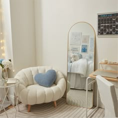 a bedroom with a chair, mirror and desk