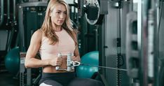 a woman sitting on a bench in a gym