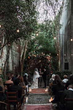 a bride and groom standing at the end of their wedding ceremony in an alleyway