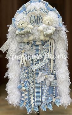 a blue and white wedding dress with teddy bears on it's chest, made out of feathers