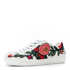 This is an authentic pair of GUCCI Calfskin Web Floral Embroidered Womens Ace Sneakers Size 35 in White. These stylish sneakers are crafted of white leather with a stunning floral pattern. They feature white laces, red and green snakeskin-embossed panels with blue bows and white rubber soles. Blue Bow, Stylish Sneakers, White Leather, White Lace, Calf Skin, Floral Pattern, Gucci, Sneakers, Lace