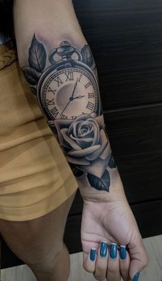 a woman's arm with a clock and rose tattoo on it