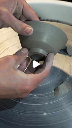 a person using a circular saw to cut wood