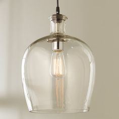 a clear glass light fixture hanging from a ceiling