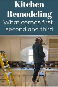 a man standing on a ladder in a kitchen