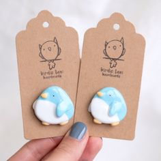 two small blue and white elephant shaped earrings