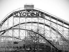 a black and white photo of a roller coaster