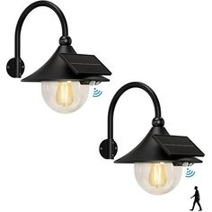 two black outdoor wall lights with one light on each side and an antenna attached to the back